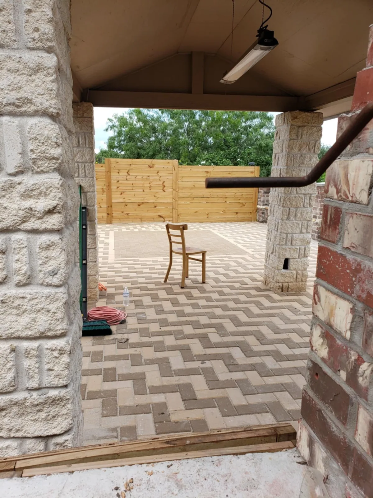 A covered outdoor patio and paved area